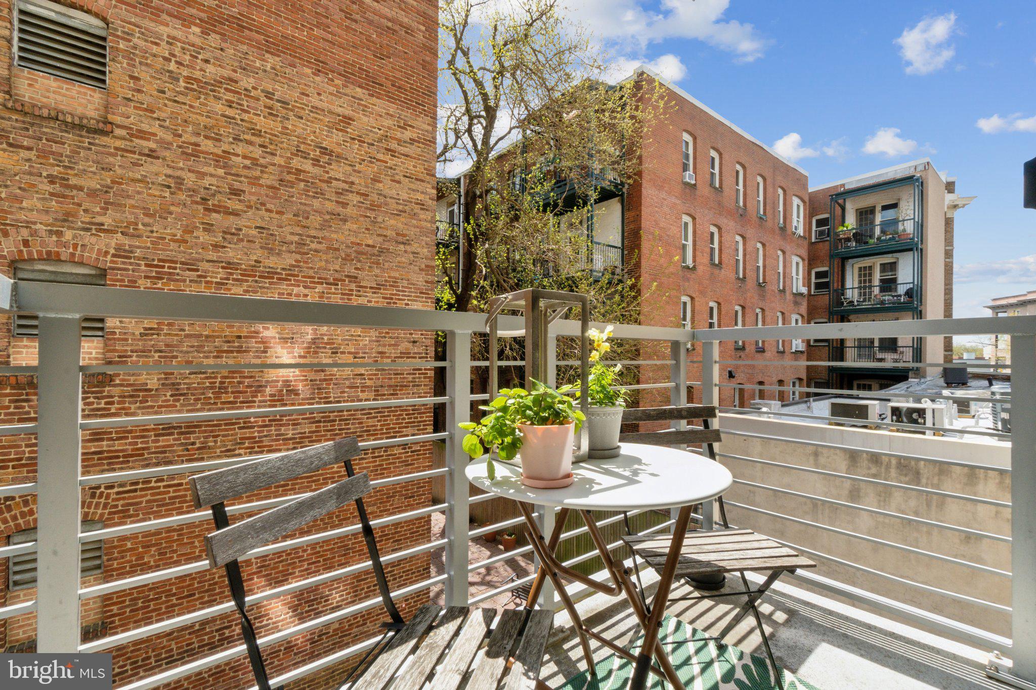 2550 17th Street Northwest, Unit 205 Washington, DC 20009 - Photo 13 of 25 a view of a patio with table and chairs and potted plants
