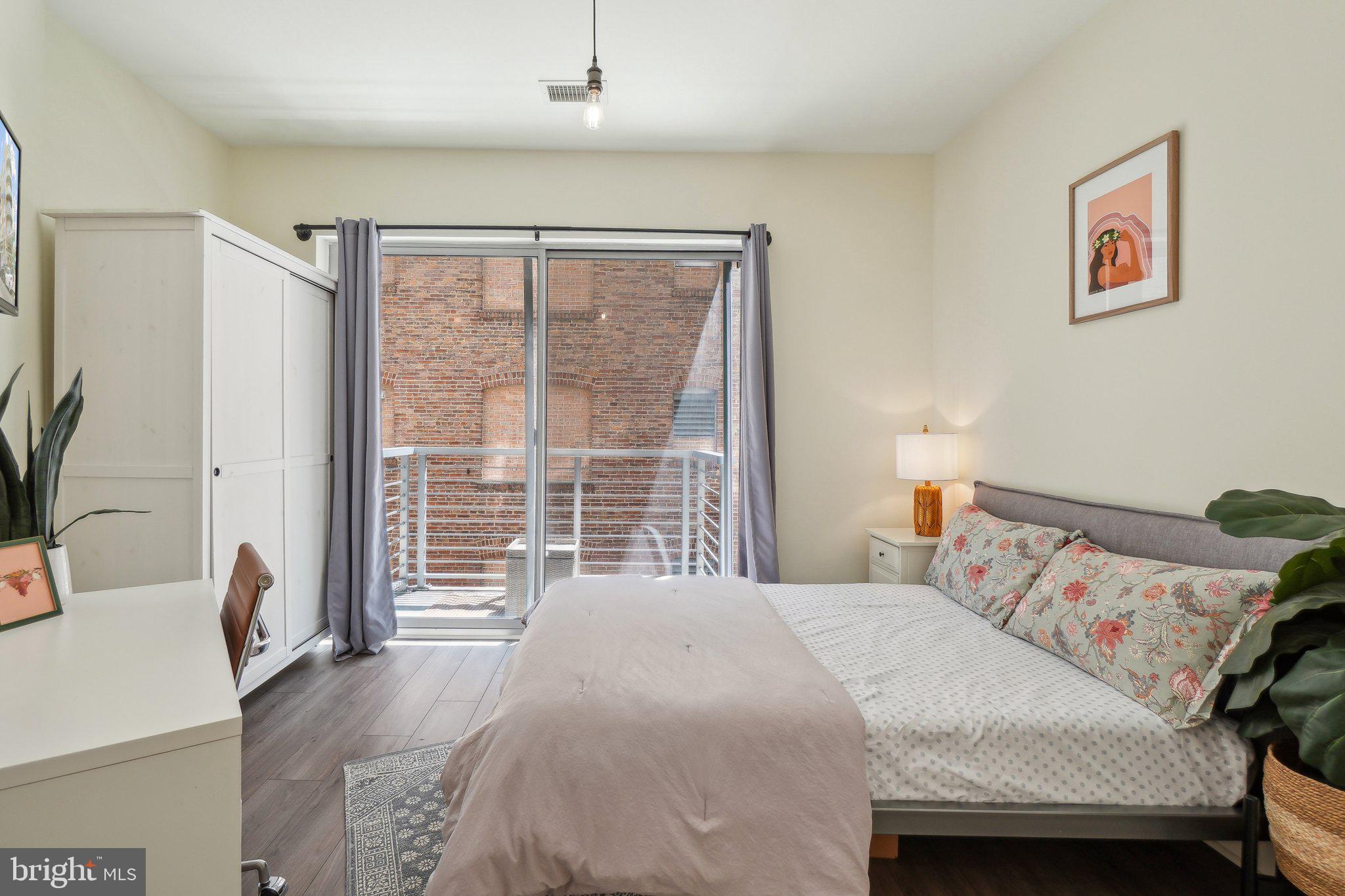 2550 17th Street Northwest, Unit 205 Washington, DC 20009 - Photo 17 of 25 a bedroom with a bed and a large window