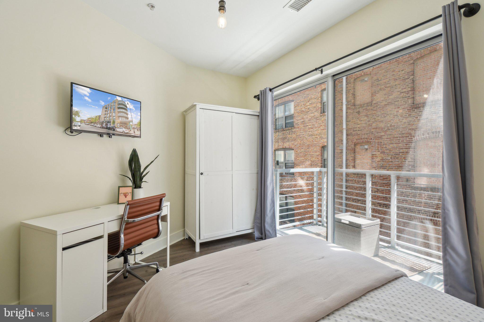 2550 17th Street Northwest, Unit 205 Washington, DC 20009 - Photo 18 of 25 a bedroom with a bed and a window
