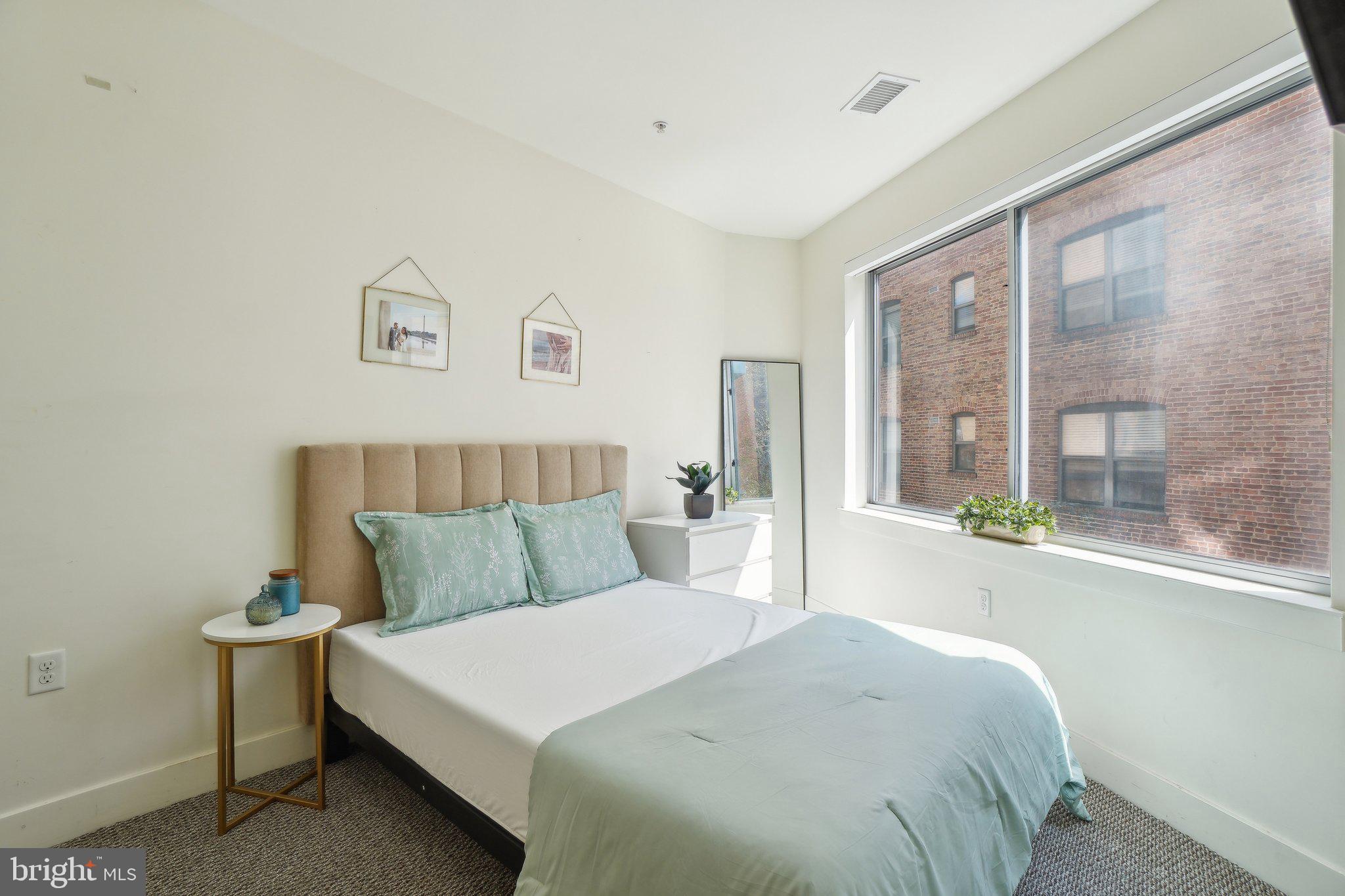 2550 17th Street Northwest, Unit 205 Washington, DC 20009 - Photo 20 of 25 a bedroom with a large bed and a large window