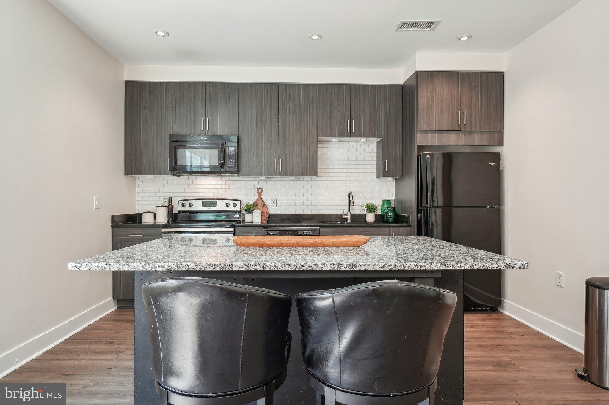2550 17th Street Northwest, Unit 205 Washington, DC 20009 - Photo 2 of 25 a kitchen with a stove a sink and a refrigerator