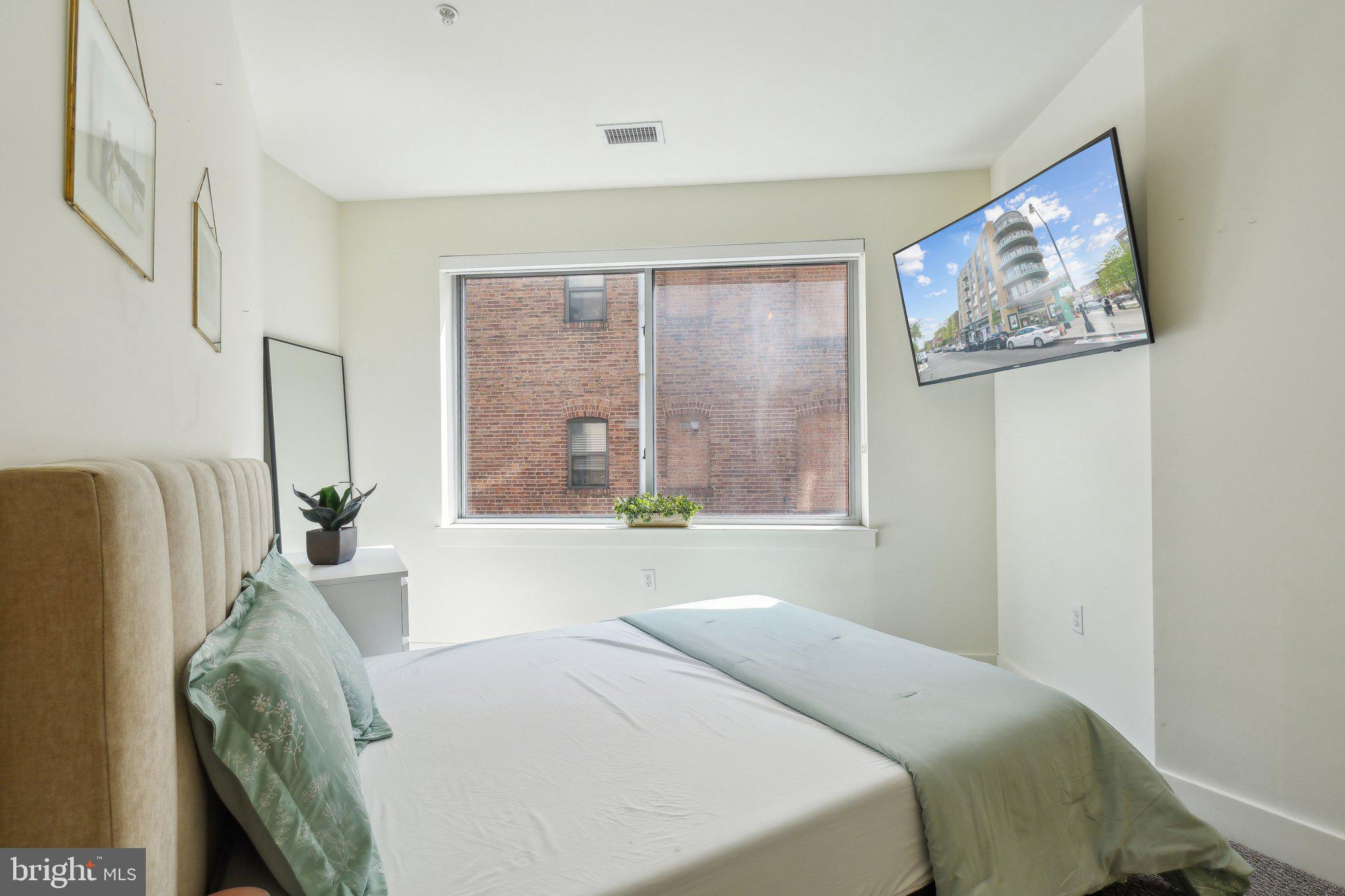 2550 17th Street Northwest, Unit 205 Washington, DC 20009 - Photo 25 of 25 a bedroom with furniture and a window
