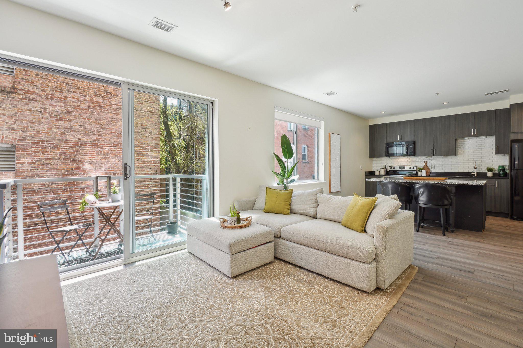 2550 17th Street Northwest, Unit 205 Washington, DC 20009 - Photo 6 of 25 a living room with furniture and a large window