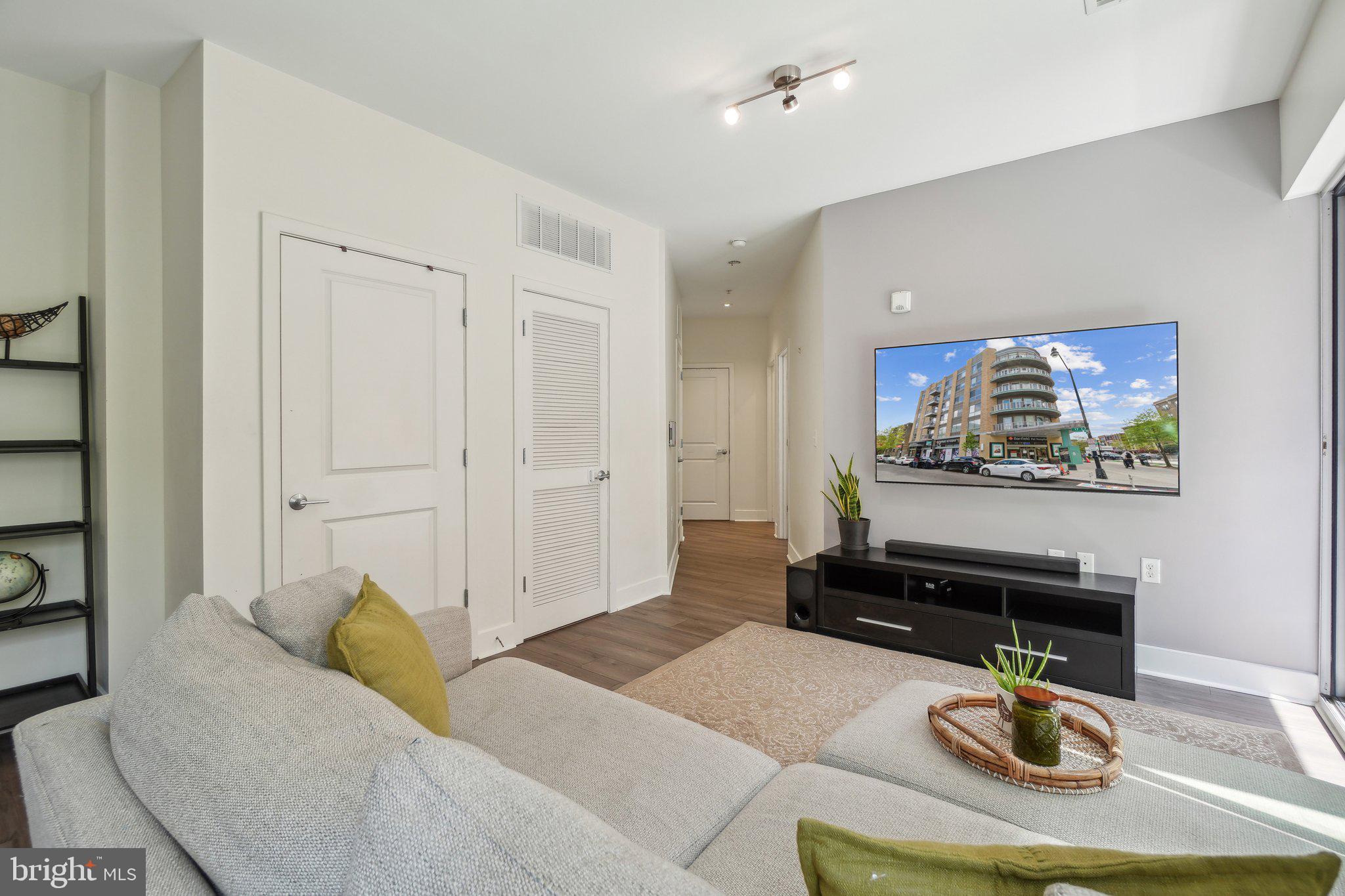 2550 17th Street Northwest, Unit 205 Washington, DC 20009 - Photo 7 of 25 a living room with furniture a rug and a wall painting