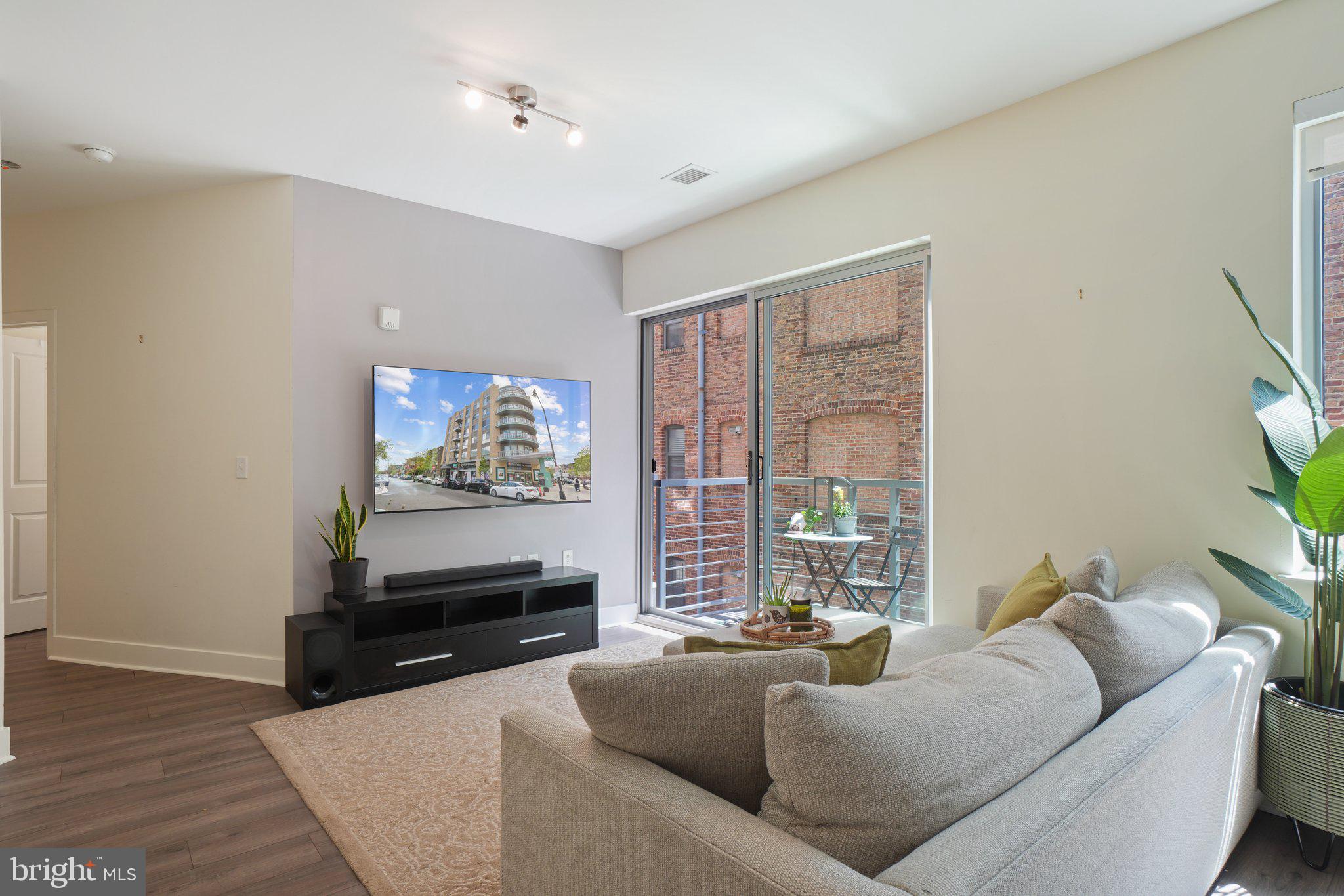 2550 17th Street Northwest, Unit 205 Washington, DC 20009 - Photo 8 of 25 a living room with furniture and a flat screen tv
