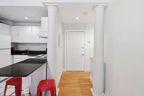 a kitchen with a refrigerator and cabinets
