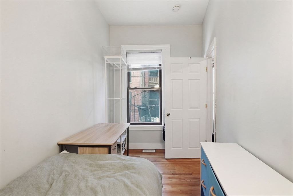 20 Symphony Road, Unit 2 Boston, MA 02115 - Photo 7 of 11 a bedroom with a bed and wooden floor