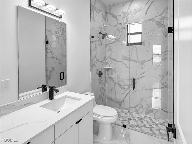 a bathroom with a sink toilet and shower