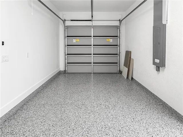 a view of a storage & utility room with refrigerator and windows