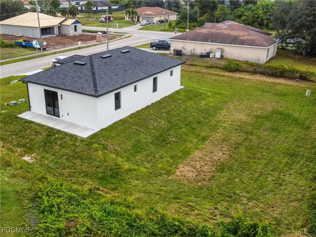 a aerial view of a house next to a big yard
