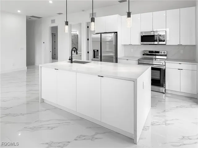 a kitchen with cabinets and stainless steel appliances