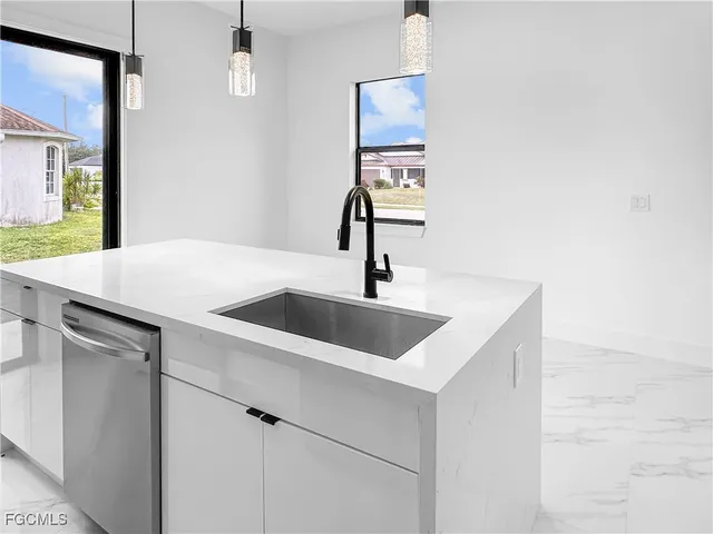 a kitchen with a sink and a mirror