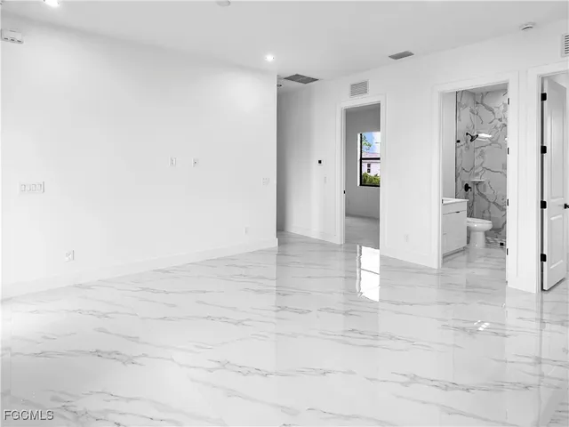 an empty room with windows and closet