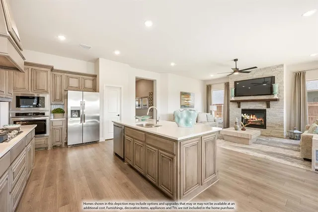 a large kitchen with a large counter top appliances and cabinets