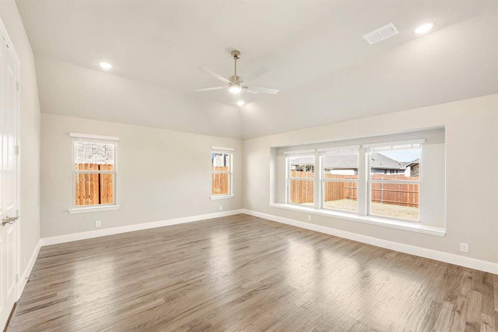 1004 Stonehaven Drive Justin, TX 76247 - Photo 20 of 35 a view of an empty room with wooden floor and a window