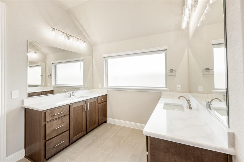 1004 Stonehaven Drive Justin, TX 76247 - Photo 23 of 35 a kitchen with a sink a window and cabinets