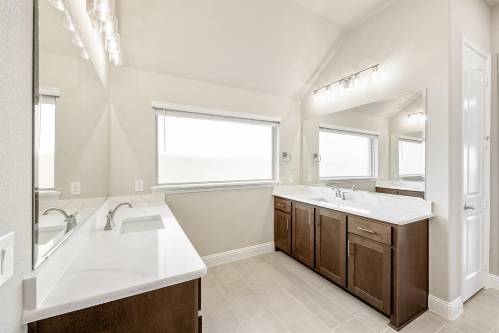 1004 Stonehaven Drive Justin, TX 76247 - Photo 24 of 35 a bathroom with a sink and a mirror