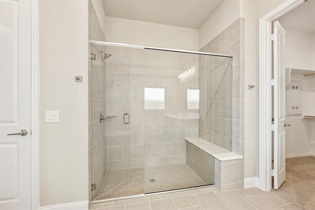 1004 Stonehaven Drive Justin, TX 76247 - Photo 25 of 35 a bathroom with a glass shower door