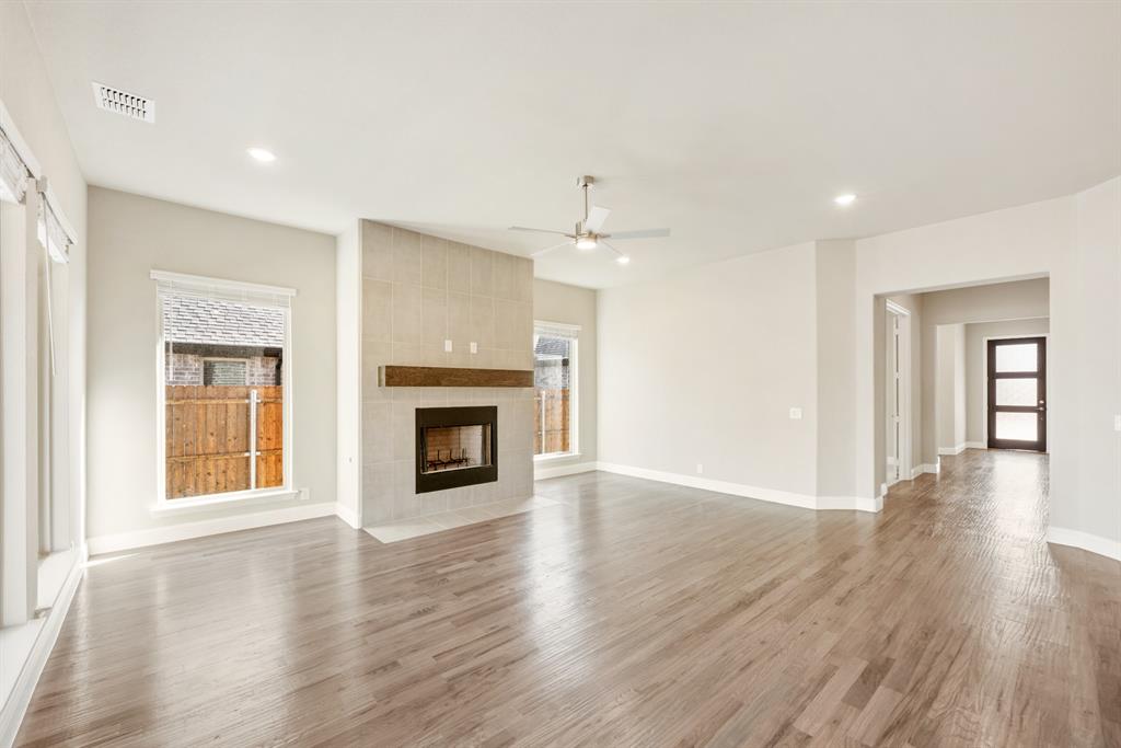 1004 Stonehaven Drive Justin, TX 76247 - Photo 6 of 35 a view of an empty room with window and wooden floor