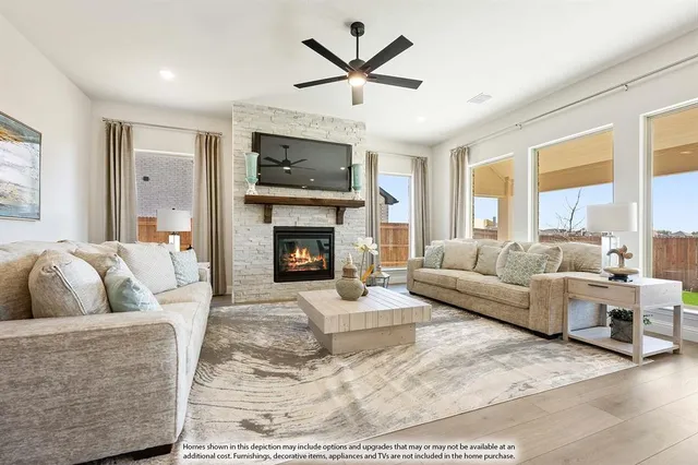 a living room with furniture fireplace and a large window
