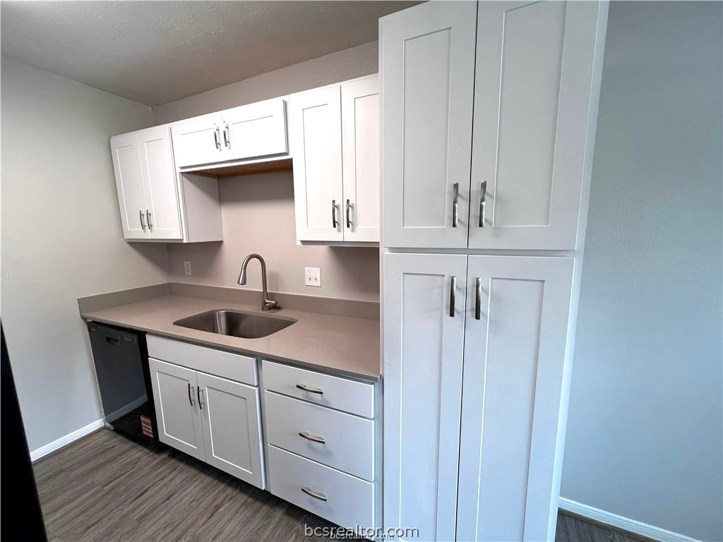 625 West Ridge Drive College Station, TX 77845 - Photo 3 of 13 a kitchen with white cabinets and sink