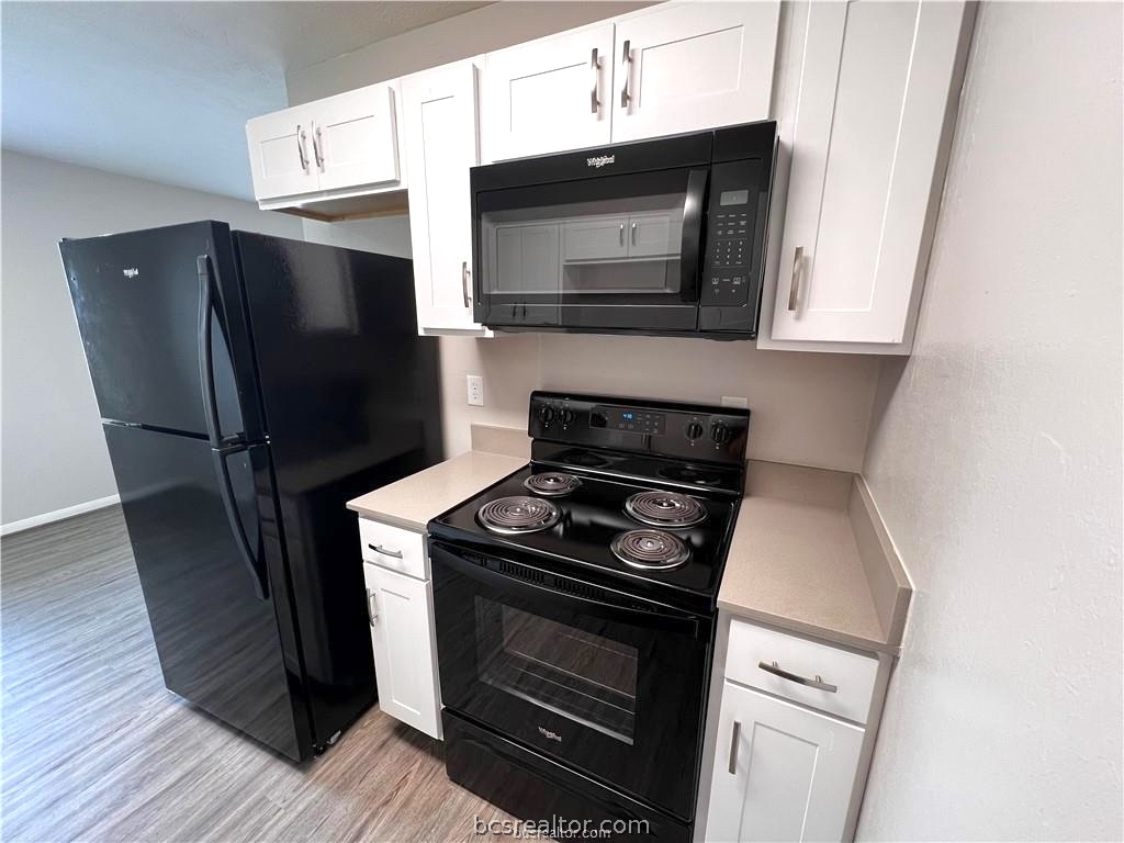 625 West Ridge Drive College Station, TX 77845 - Photo 4 of 13 a kitchen with stainless steel appliances a stove microwave and sink