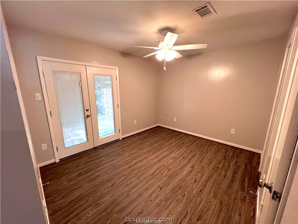 625 West Ridge Drive College Station, TX 77845 - Photo 7 of 13 an empty room with wooden floor fan and windows
