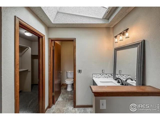 a view of a bathroom with a sink and mirror