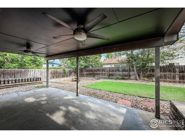 a view of a porch with furniture and garden