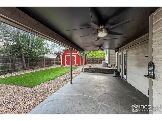 a view of a porch with furniture and a yard