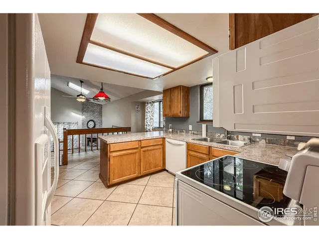 a kitchen with granite countertop a sink and cabinets