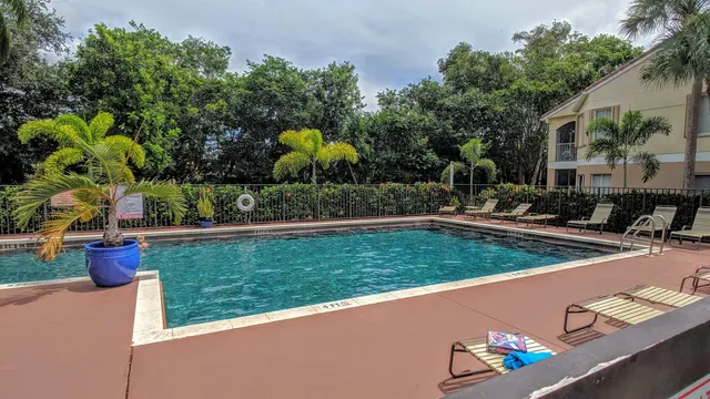 a view of a backyard and swimming pool