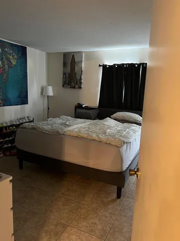 a bedroom with a bed and mirror