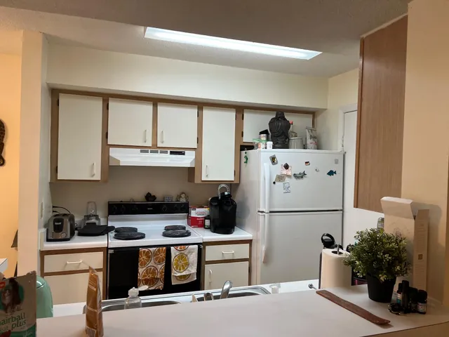 a kitchen with a refrigerator and cabinets