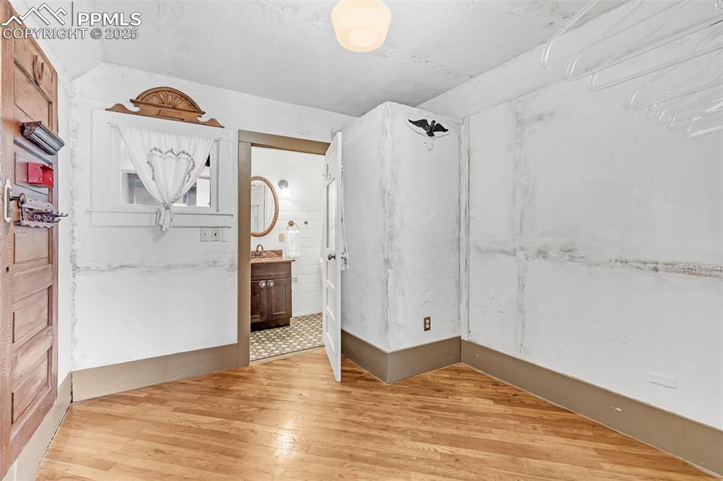 123 7th Street Victor, CO 80860 - Photo 16 of 50 Extra large closet off main bedroom with access to 3/4 bath and featuring wood floors.