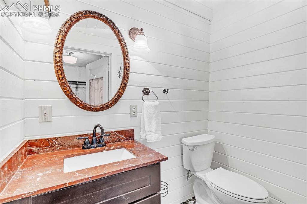 123 7th Street Victor, CO 80860 - Photo 20 of 50 Bathroom with toilet and vanity and shower off the main bedroom. Mirror opens to reveal medicine cabinet.