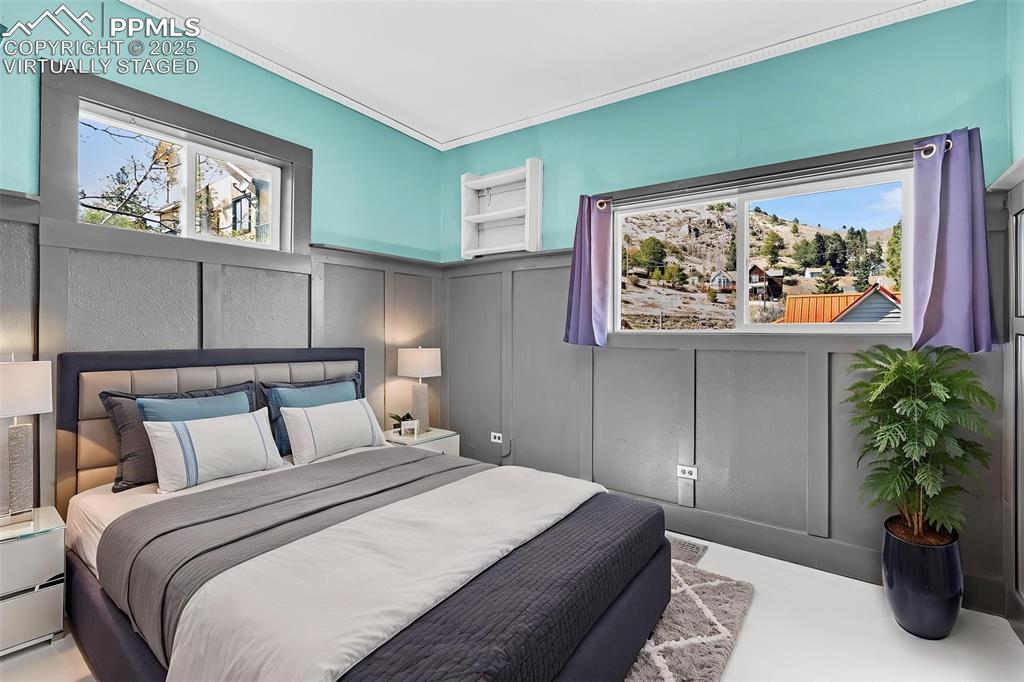 123 7th Street Victor, CO 80860 - Photo 27 of 50 Virtually Staged Bedroom featuring a decorative wall and wainscoting