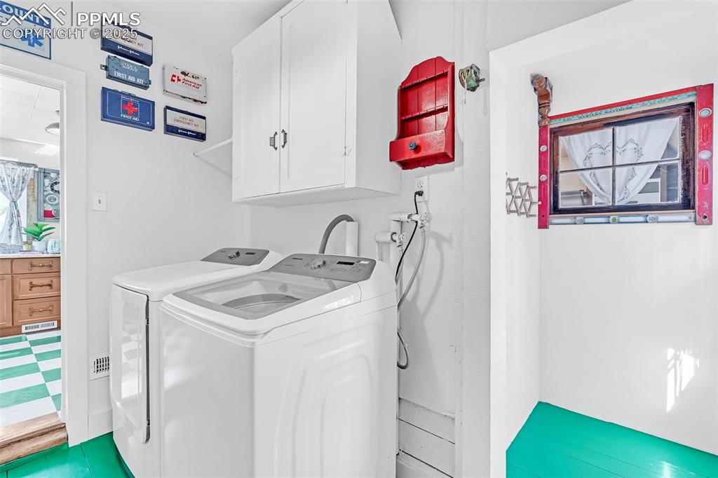 123 7th Street Victor, CO 80860 - Photo 40 of 50 Laundry with cabinet space and washer and clothes dryer provides access to fenced yard and garage