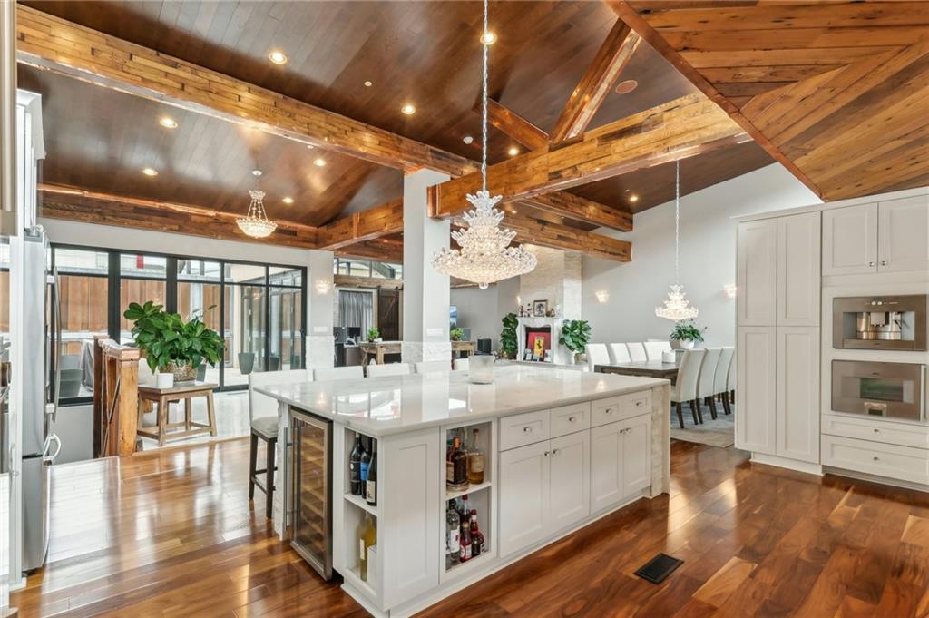 215 25th Street, Unit 7 Pittsburgh, PA 15222 - Photo 13 of 49 a large white kitchen with stainless steel appliances granite countertop a stove and wooden floor