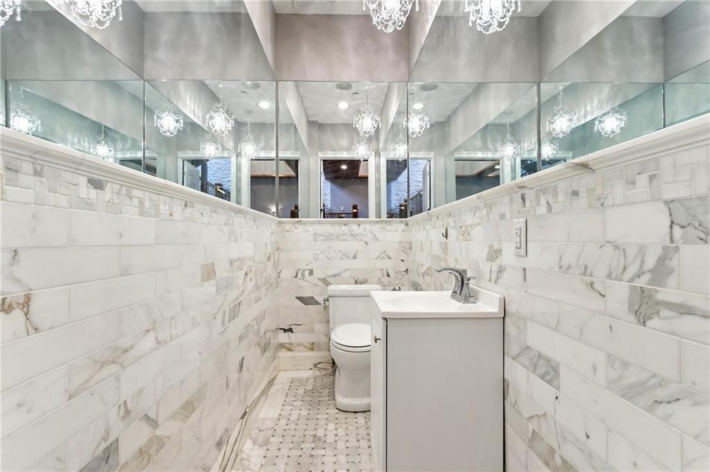 215 25th Street, Unit 7 Pittsburgh, PA 15222 - Photo 19 of 49 a bathroom with a sink a toilet and mirror