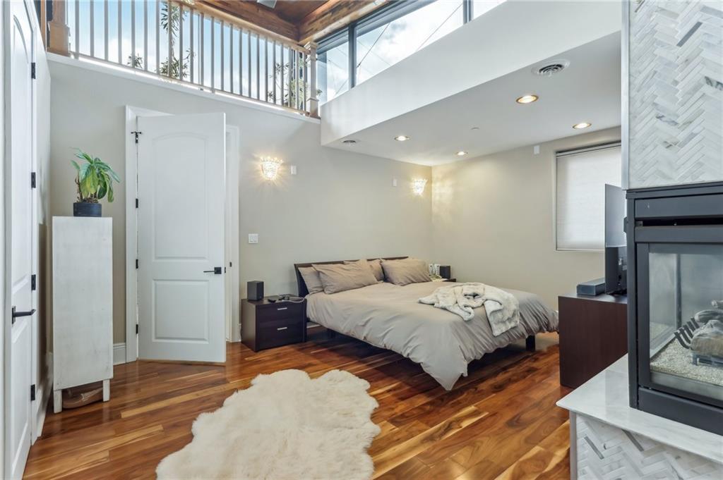 215 25th Street, Unit 7 Pittsburgh, PA 15222 - Photo 20 of 49 a bedroom with a bed and a mirror