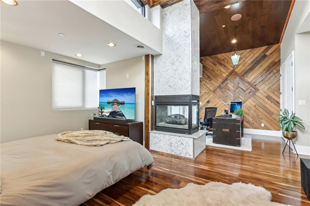 215 25th Street, Unit 7 Pittsburgh, PA 15222 - Photo 23 of 49 a bedroom with a bed and a fireplace