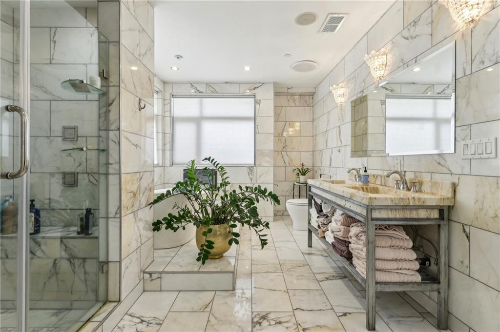 215 25th Street, Unit 7 Pittsburgh, PA 15222 - Photo 26 of 49 a bathroom with a sink and shower