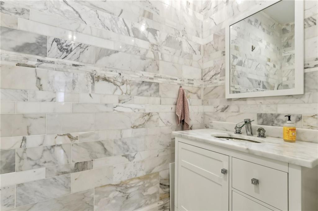 215 25th Street, Unit 7 Pittsburgh, PA 15222 - Photo 28 of 49 a bathroom with a sink mirror and vanity