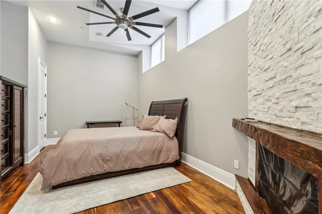 215 25th Street, Unit 7 Pittsburgh, PA 15222 - Photo 29 of 49 a bedroom with a bed and a chandelier