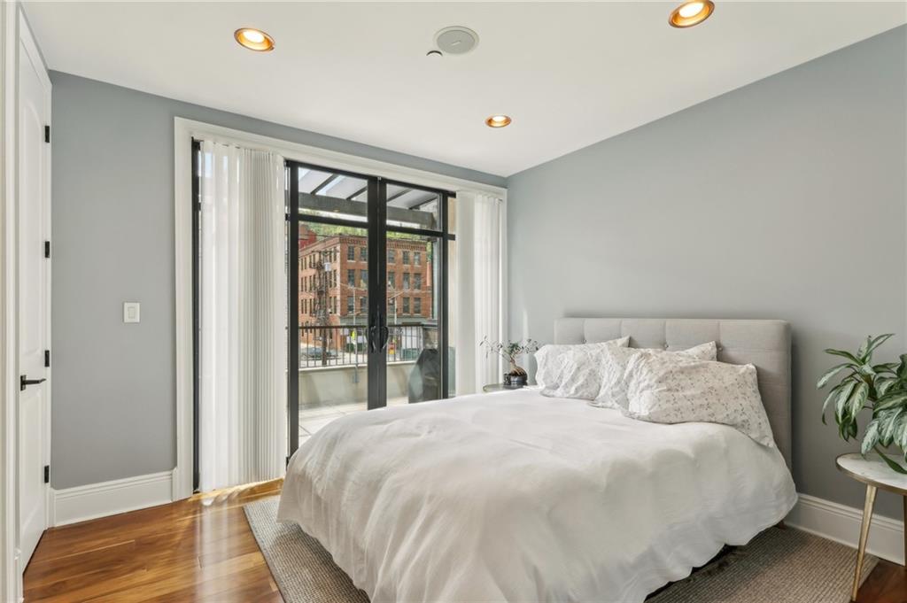 215 25th Street, Unit 7 Pittsburgh, PA 15222 - Photo 32 of 49 a large bed sitting in a bedroom next to a window