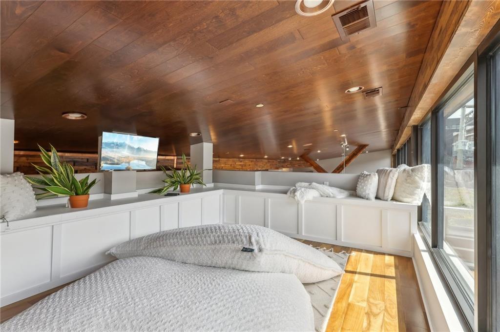 215 25th Street, Unit 7 Pittsburgh, PA 15222 - Photo 34 of 49 a large white kitchen with kitchen island granite countertop a large window and a white counter top