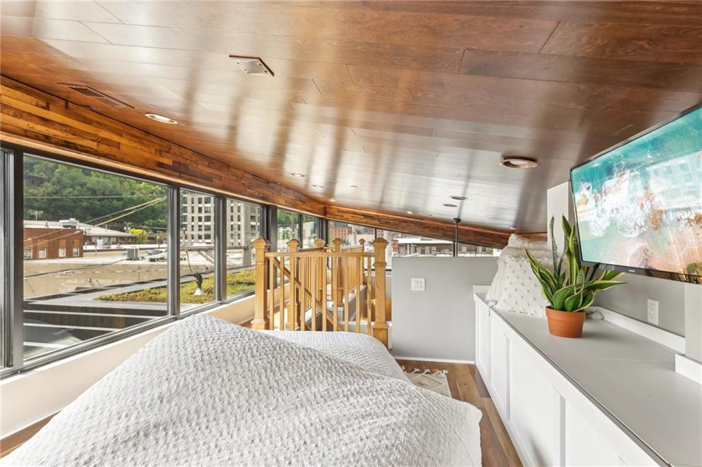 215 25th Street, Unit 7 Pittsburgh, PA 15222 - Photo 35 of 49 a spacious bedroom with a large window and potted plant