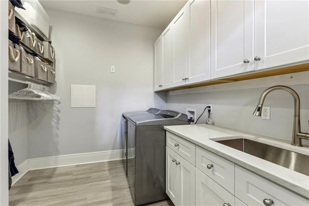 215 25th Street, Unit 7 Pittsburgh, PA 15222 - Photo 36 of 49 a kitchen with stainless steel appliances granite countertop a sink and cabinets with wooden floor