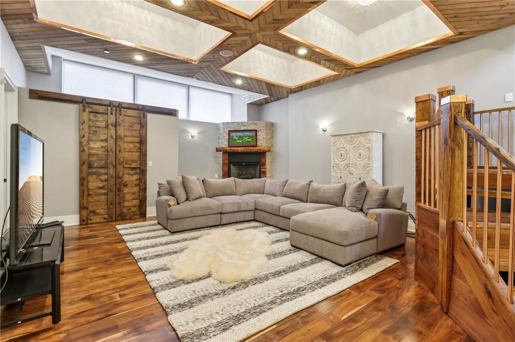 215 25th Street, Unit 7 Pittsburgh, PA 15222 - Photo 4 of 49 a living room with furniture a flat screen tv and kitchen view